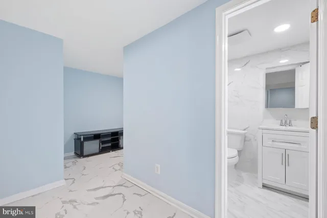 a bathroom with a sink a toilet and vanity