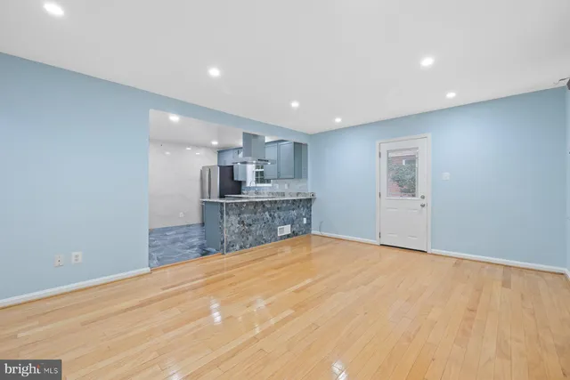 a view of a kitchen with a sink and a refrigerator