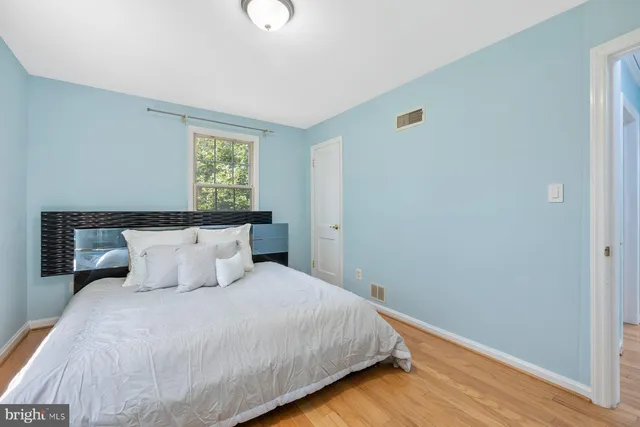 a bedroom with bed and window