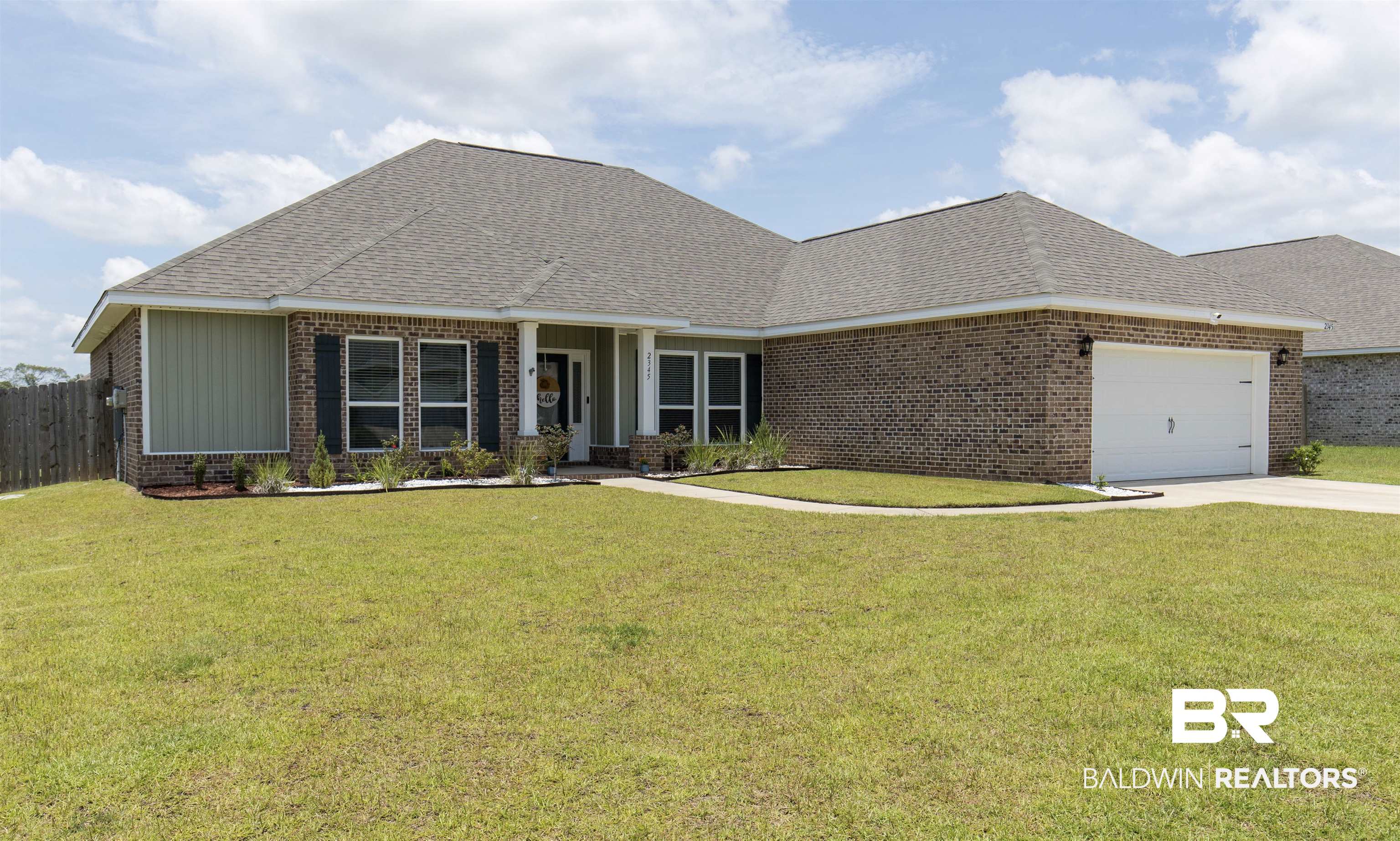 2345 Laurel Street Semmes, AL 36575 - Photo 2 of 31 View of front of house with brick siding, an attached garage, concrete driveway, and roof with shingles