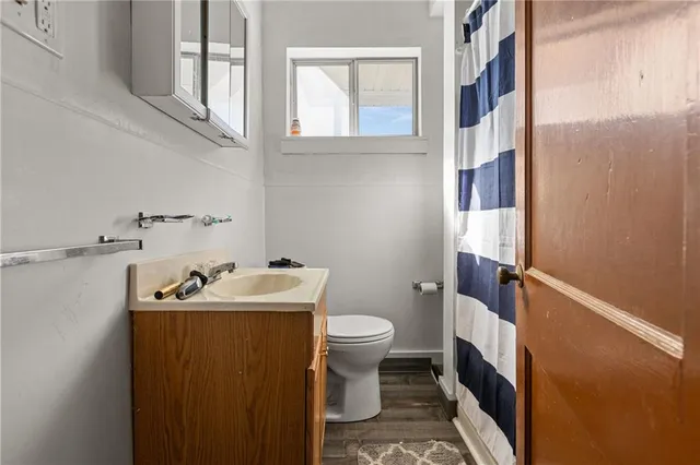 a bathroom with a sink toilet and a mirror