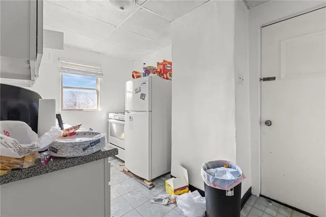 a kitchen with granite countertop white cabinets and sink