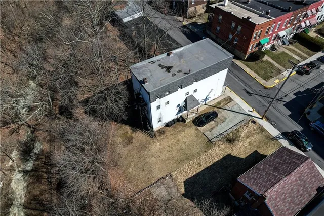 an aerial view of a house with a yard