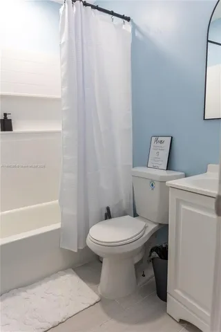 a bathroom with a toilet and a bathtub
