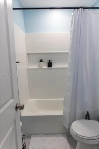 a bathroom with a bathtub and a toilet