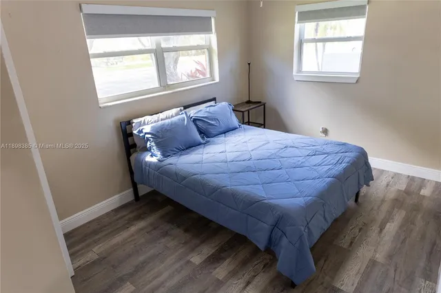 a bed sitting in a bedroom next to a window