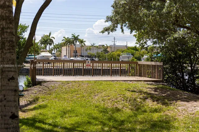 a view of backyard with table and chairs and wooden fence