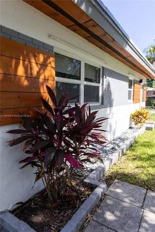 a view of a house with a flower garden
