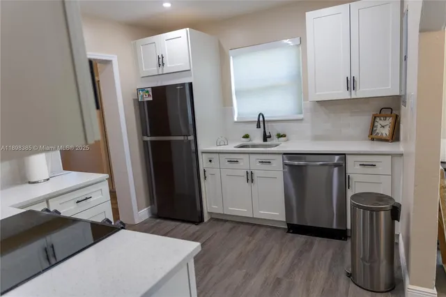 a kitchen with a sink stove and refrigerator