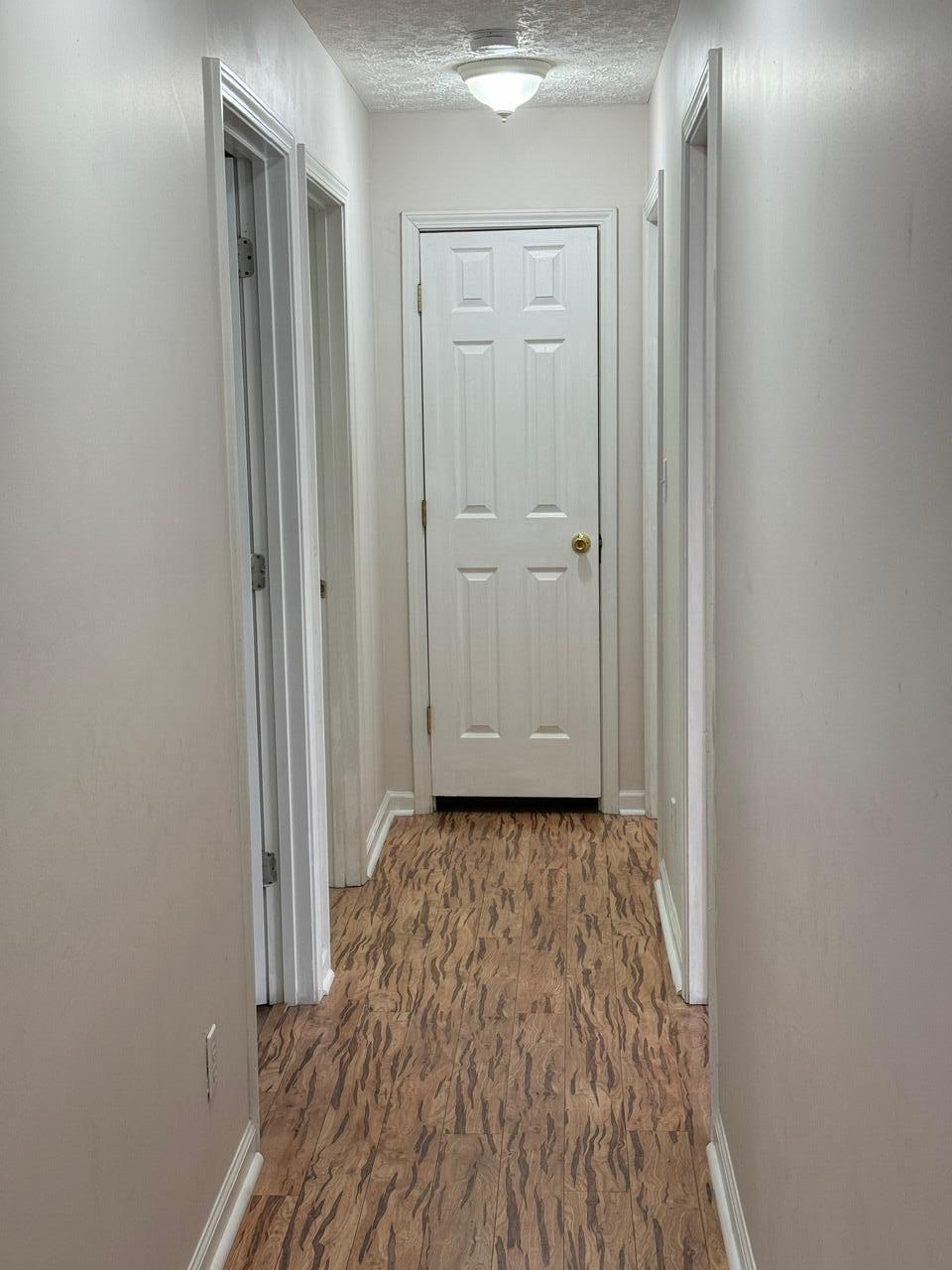 225 Bay Grove Road Freeport, FL 32439 - Photo 16 of 33 a view of a livingroom with wooden floor and a hallway