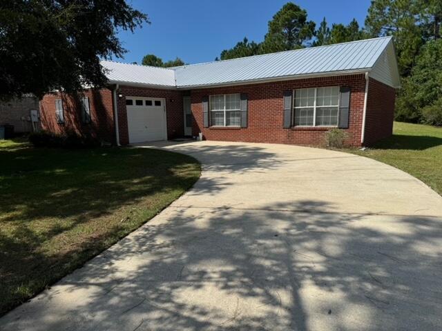 225 Bay Grove Road Freeport, FL 32439 - Photo 2 of 33 a front view of a house with a garden