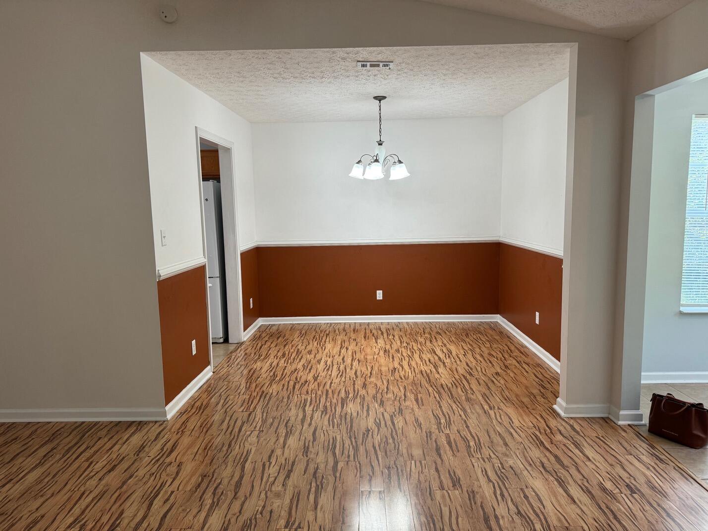 225 Bay Grove Road Freeport, FL 32439 - Photo 21 of 33 a view of a room with wooden floor and chandelier