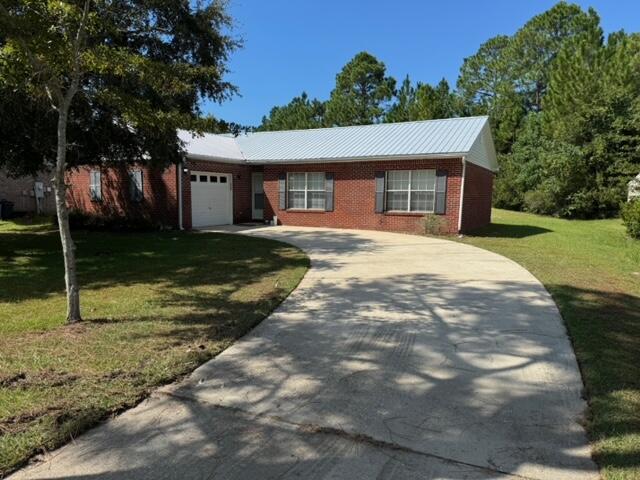 225 Bay Grove Road Freeport, FL 32439 - Photo 3 of 33 a front view of a house with a yard