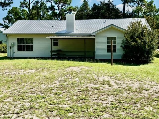 225 Bay Grove Road Freeport, FL 32439 - Photo 4 of 33 a front view of a house with a yard