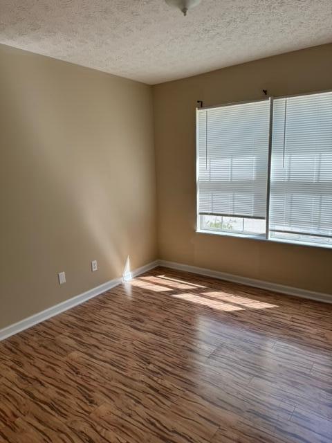 225 Bay Grove Road Freeport, FL 32439 - Photo 8 of 33 a view of an empty room with wooden floor and a window