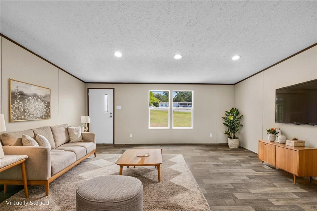 2919 High Shoals Road Anderson, SC 29624 - Photo 2 of 21 This inviting living space features warm flooring and ample natural light, creating a comfortable atmosphere.