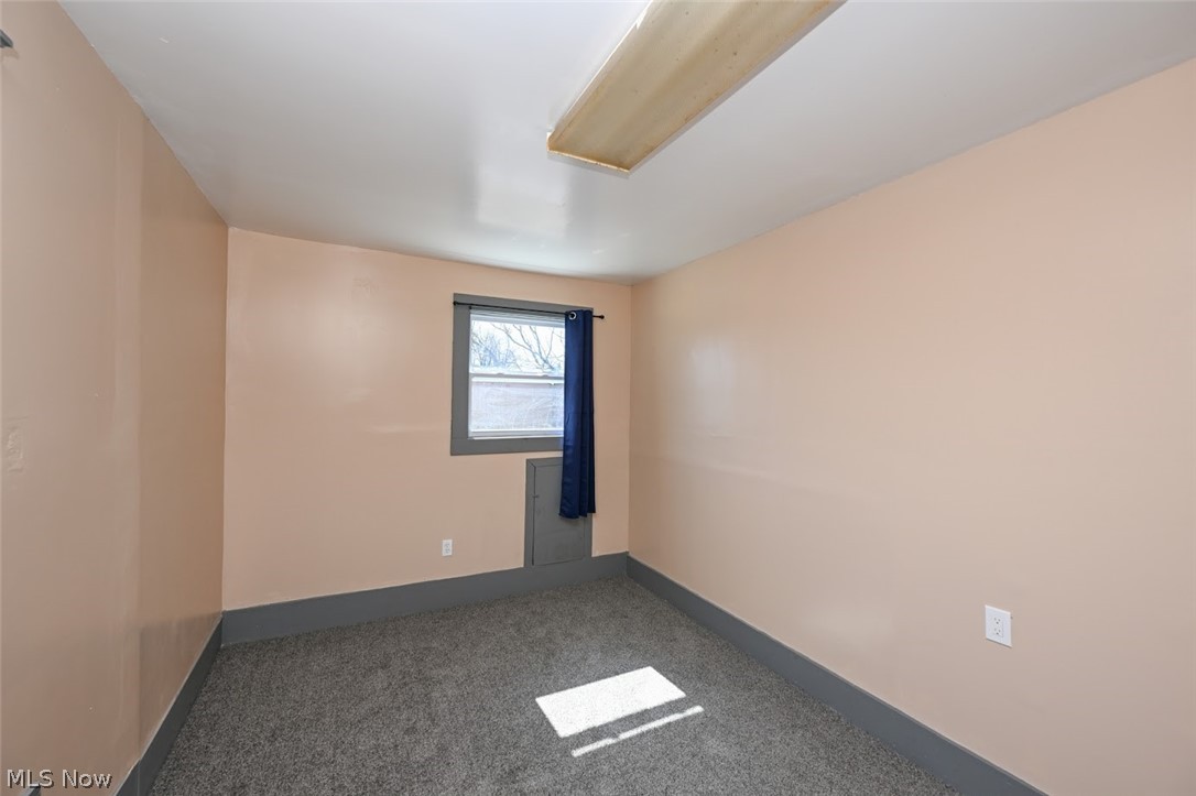 868 North Main Street Akron, OH 44310 - Photo 19 of 30 Spare room featuring dark carpet and baseboards