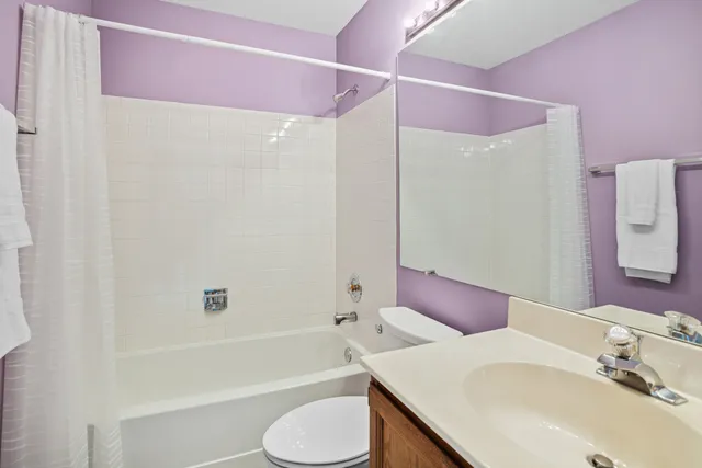 a bathroom with a sink toilet vanity and shower
