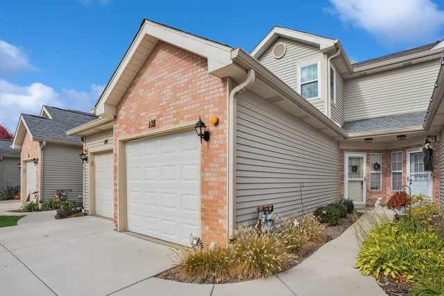 a view of a house with a small yard and plants