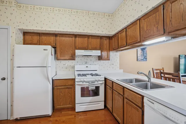 a kitchen with a sink cabinets and stainless steel appliances
