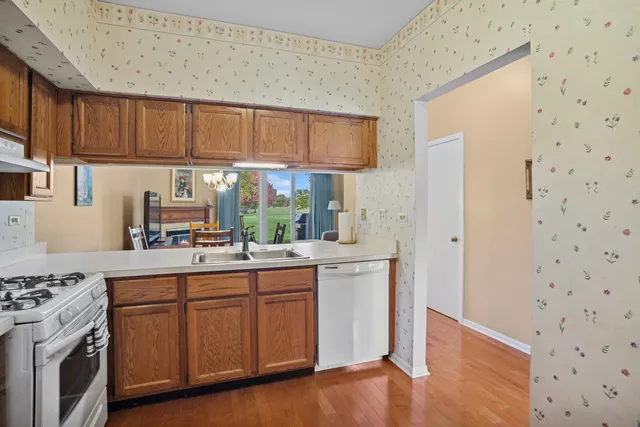 a kitchen with a sink stove and cabinets