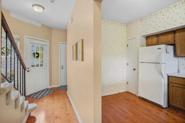 a view of hallway with wooden floor and electronic appliances