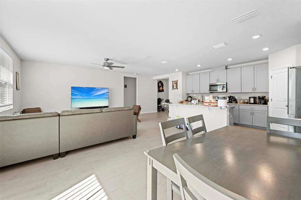 12354 Huron Street Spring Hill, FL 34609 - Photo 11 of 48 a living room with stainless steel appliances furniture a dining table and kitchen view