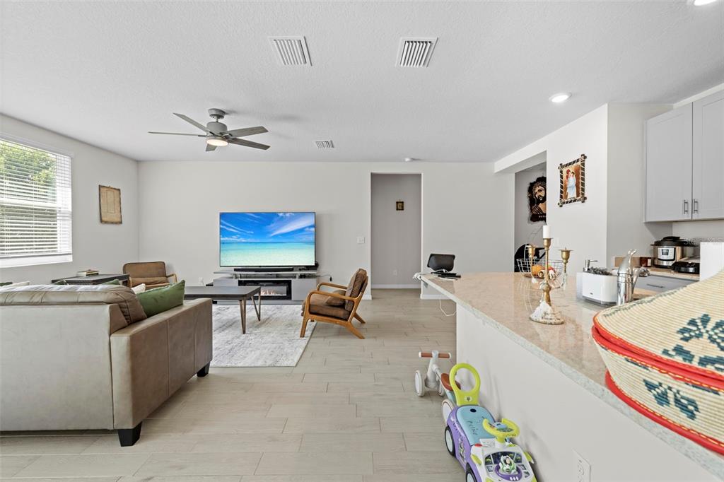 12354 Huron Street Spring Hill, FL 34609 - Photo 13 of 48 a living room with furniture and flat screen tv