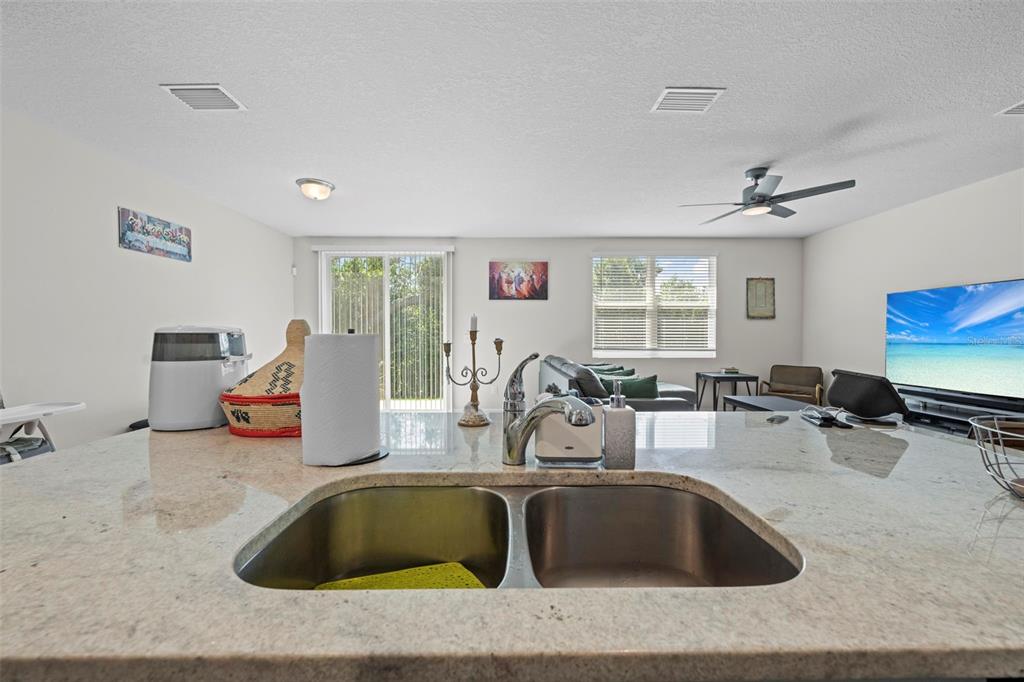 12354 Huron Street Spring Hill, FL 34609 - Photo 15 of 48 a living room with furniture and a flat screen tv