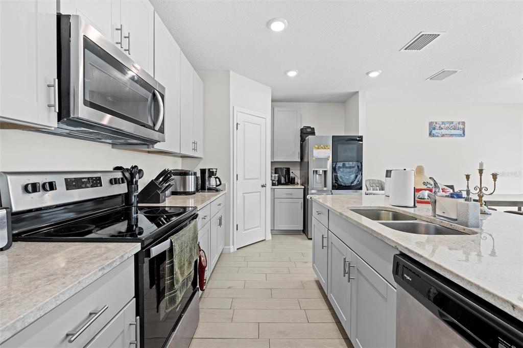 12354 Huron Street Spring Hill, FL 34609 - Photo 16 of 48 a kitchen with stainless steel appliances a sink stove and cabinets