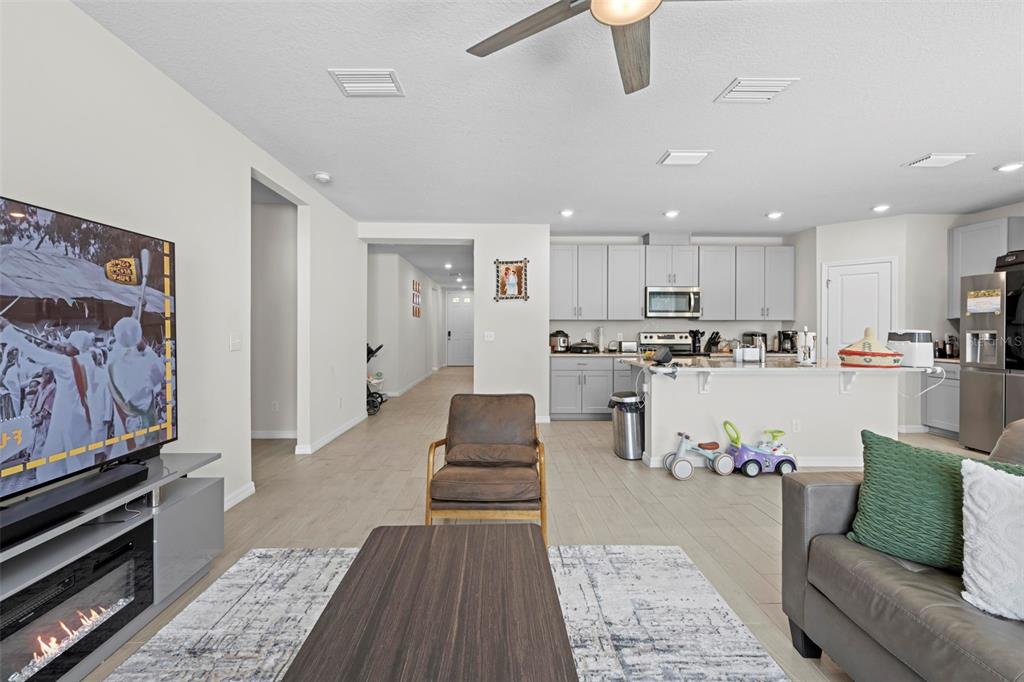 12354 Huron Street Spring Hill, FL 34609 - Photo 17 of 48 a living room with stainless steel appliances furniture and a rug