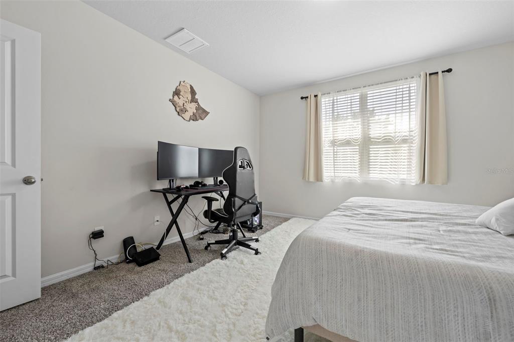 12354 Huron Street Spring Hill, FL 34609 - Photo 22 of 48 a bedroom with bed and a window