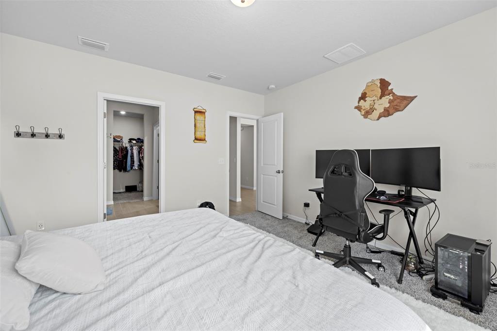 12354 Huron Street Spring Hill, FL 34609 - Photo 23 of 48 a bedroom with a bed and a flat screen tv