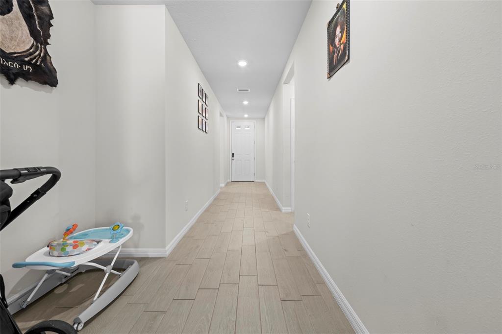 12354 Huron Street Spring Hill, FL 34609 - Photo 29 of 48 a hallway with table and couch