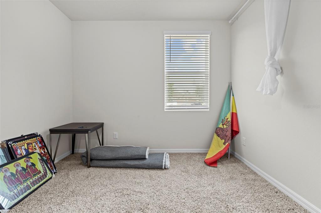 12354 Huron Street Spring Hill, FL 34609 - Photo 32 of 48 a living room with furniture and a lamp