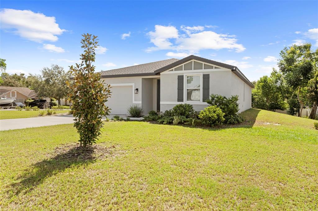 12354 Huron Street Spring Hill, FL 34609 - Photo 39 of 48 a front view of house with yard and green space