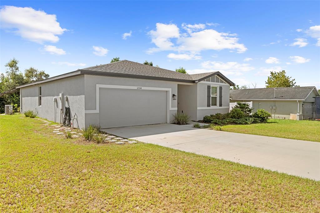 12354 Huron Street Spring Hill, FL 34609 - Photo 4 of 48 a front view of a house with a yard