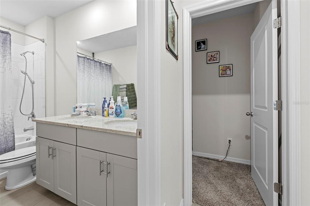 12354 Huron Street Spring Hill, FL 34609 - Photo 42 of 48 a bathroom with a double vanity sink toilet and shower