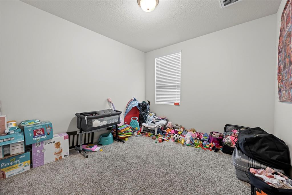12354 Huron Street Spring Hill, FL 34609 - Photo 43 of 48 a room with toys and storage