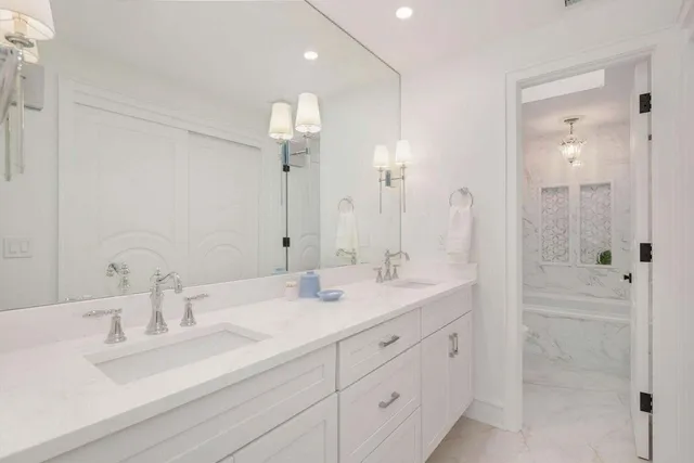 a bathroom with double sink and a mirror