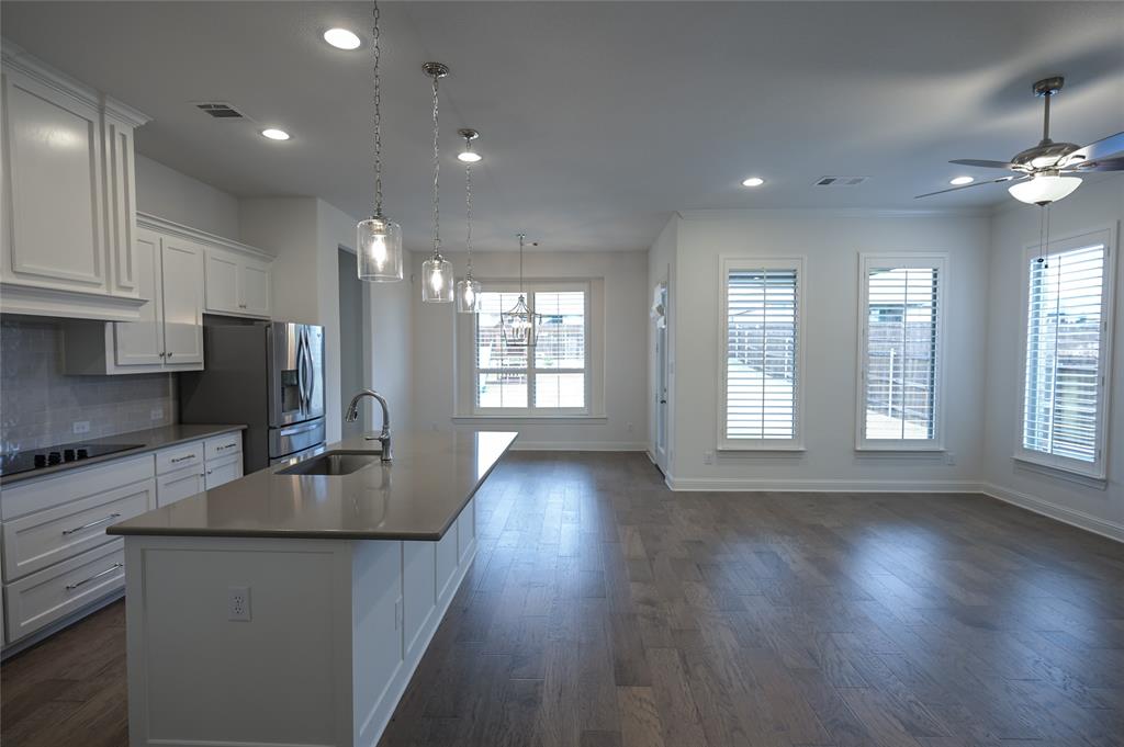 809 Deleon Drive Midlothian, TX 76065 - Photo 12 of 30 Kitchen with white cabinetry, decorative backsplash, recessed lighting, stainless steel refrigerator with ice dispenser, and wood-style floors
