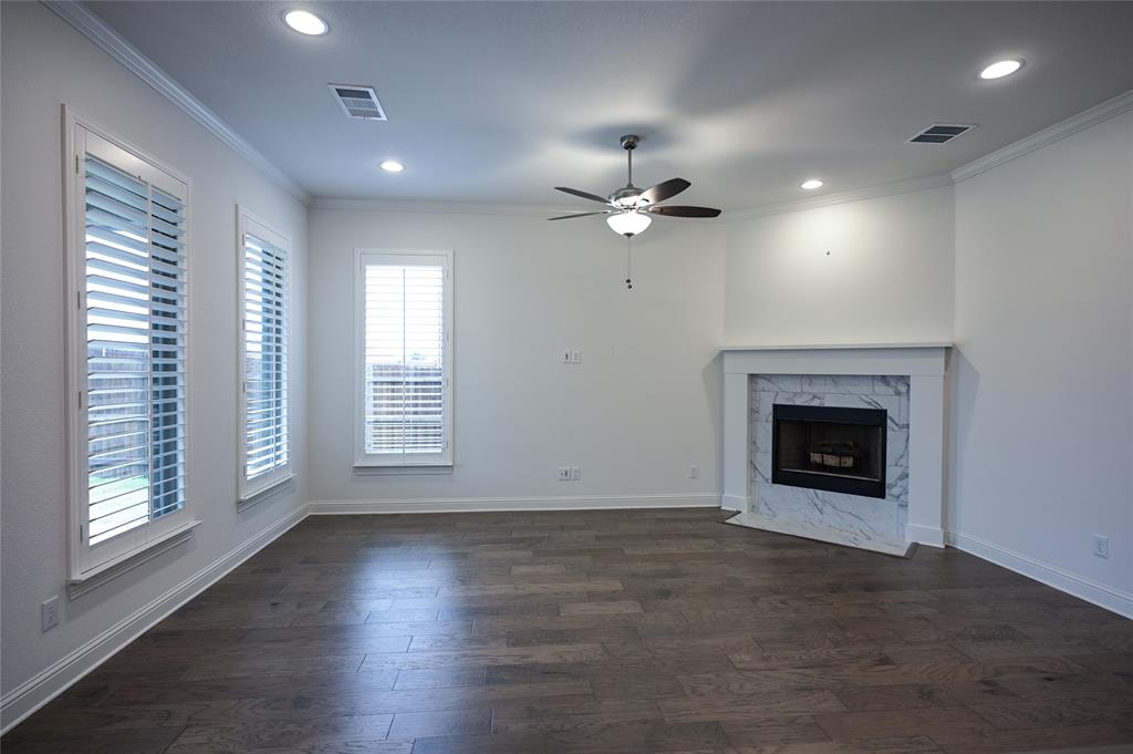 809 Deleon Drive Midlothian, TX 76065 - Photo 14 of 30 Living room with Plantation Shutters, a fireplace, wood-style flooring, recessed lighting, and a ceiling fan