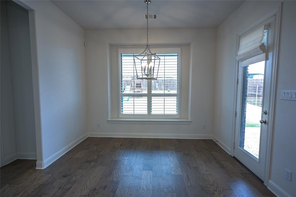 809 Deleon Drive Midlothian, TX 76065 - Photo 17 of 30 ining area featuring wood finished floors and a chandelier