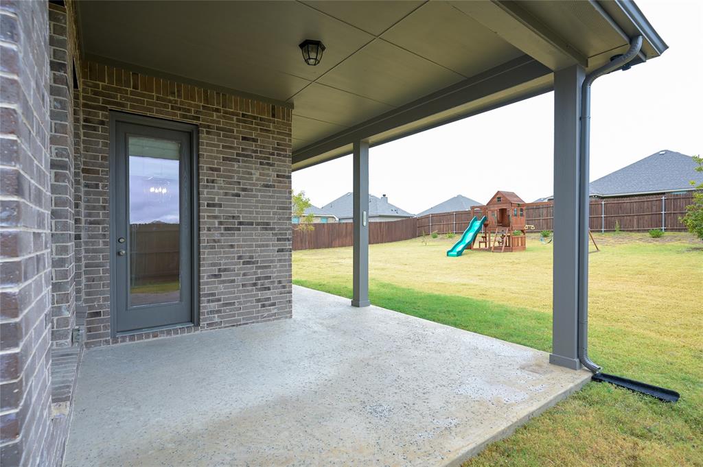 809 Deleon Drive Midlothian, TX 76065 - Photo 27 of 30 Fenced backyard with a patio and a playground