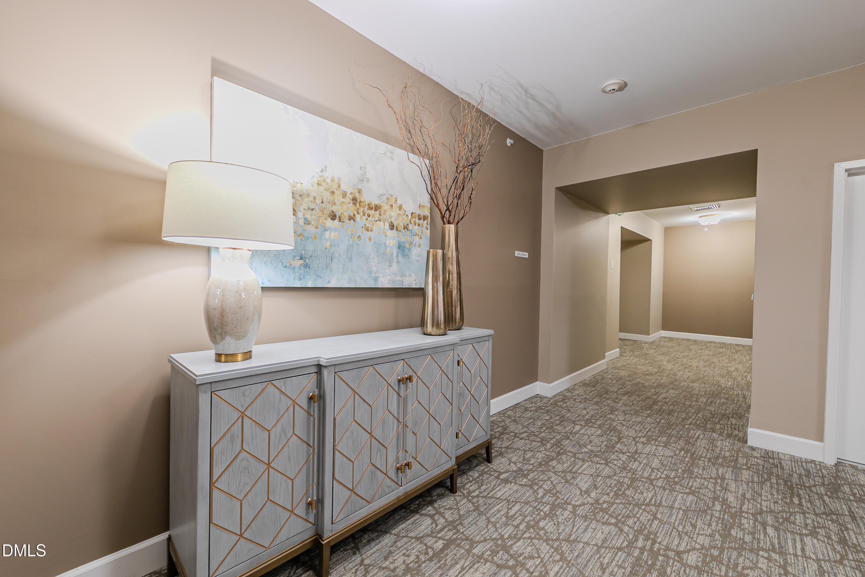116 Northbrook Drive, Unit 305 Raleigh, NC 27609 - Photo 20 of 43 a bedroom with a bed and a lamp