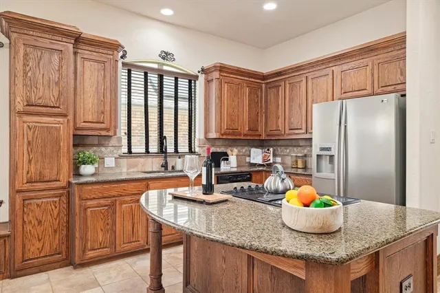 a kitchen with granite countertop a sink appliances and cabinets