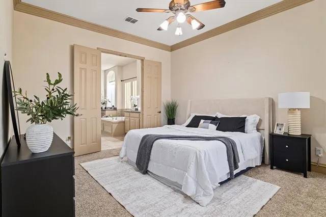 a bedroom with a bed and ceiling fan