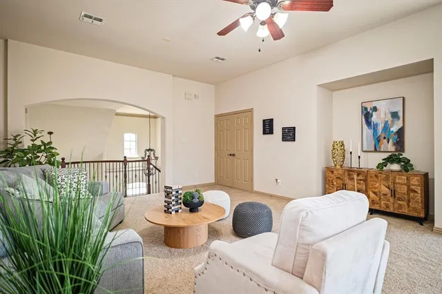 a living room with furniture potted plant and a window