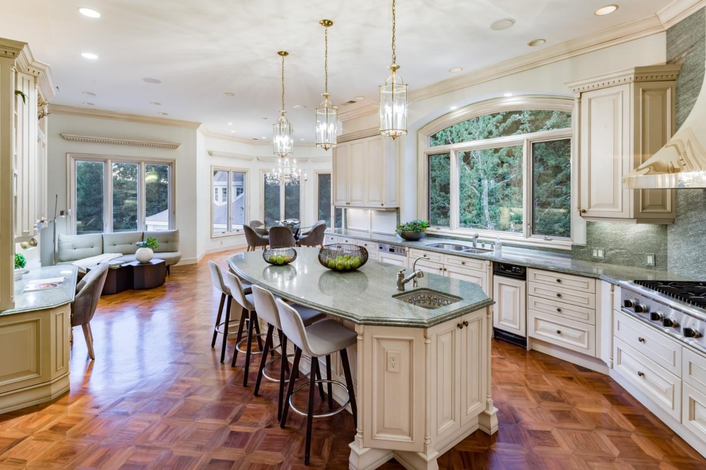 97 Ridge View Drive Atherton, CA 94027 - Photo 9 of 43 a kitchen with stainless steel appliances granite countertop a stove a sink a dining table and chairs with wooden floor