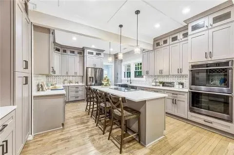 a kitchen with cabinets a sink and appliances